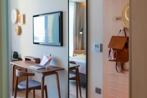 a hotel room with a desk with a laptop on it at Hotel Indigo Larnaca - Adults Only, an IHG Hotel in Larnaca