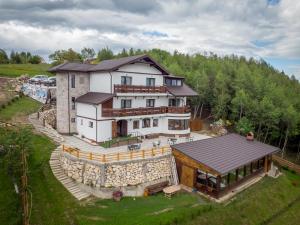 an aerial view of a large white house at Acasa la Mariuca in Bran