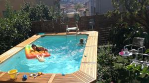 a small swimming pool with a child in a raft at Lucky House in La Spezia