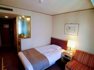 Postel nebo postele na pokoji v ubytování Tokyo Grand Hotel
