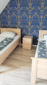 a bedroom with two beds and a blue wall at Monteurzimmer/Ferienwohnung Roßheidestraße, Gladbeck in Gladbeck
