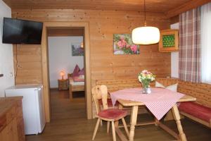 a kitchen and dining room with a table and chairs at Haus Strobler in Going