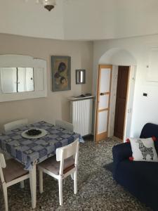 a living room with a table and chairs and a couch at Casa Bettina in Ostuni