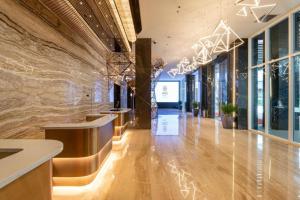 a lobby of a building with lights on the wall at Ames Hotel in Melaka