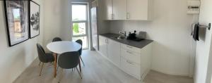 a kitchen with a table and chairs and a window at Just-Sleep in Brande