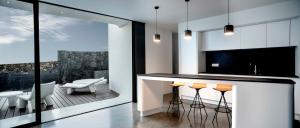 a kitchen with a bar with a view of a balcony at VULKANO LOFT in Mala