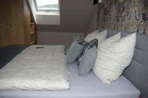 a bed with pillows on it in a room at Ferienwohnung 'Burgblick' in Wertheim