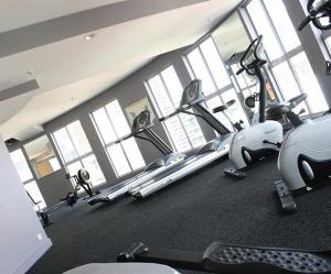 a gym with a row of treadmills and exercise bikes at Accommodation Sydney 38 Harbour Street Sydney in Sydney