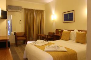 a hotel room with two towels on a bed at Hotel do Cerrado in Lamego