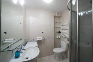 a bathroom with a sink and a toilet and a shower at Main Square Studio with TERRACE & Air condition in Krakow