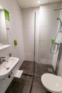 a bathroom with a shower and a sink at Court Garden Hotel - Ecodesigned in The Hague