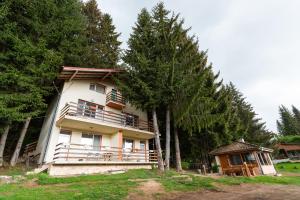 a house with trees in front of it at Orlino Holiday Park in Sarnitsa