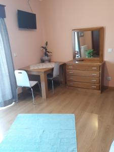 a room with a desk with two chairs and a mirror at Cynda´s home in Viseu