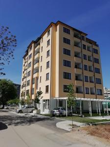 a tall building with cars parked in front of it at Valentina Bg Apartment in Sofia