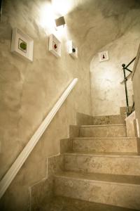 un escalier dans un bâtiment avec quelques photos sur le mur dans l'établissement Appartament Home Maria, à Naples