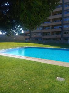 an empty swimming pool in front of a building at Great Apartment Belavista in Leça da Palmeira