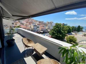 a balcony with chairs and a view of a city at Urban Loft & Urban Flat 2024 in Kavala