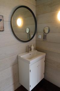 a bathroom with a sink and a mirror at Canopy Villa Glamping Park in Kampong Sum Sum