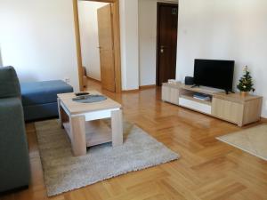 a living room with a couch and a coffee table at Apartman Tedi in Zlatibor