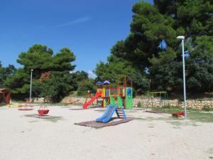 a park with a playground with a slide at Apartment Dragica in Sveti Filip i Jakov