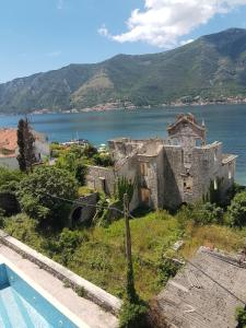an old building next to a body of water at Apartment FUNNY in Kotor