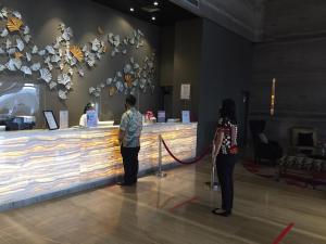 two people standing in front of a display in a museum at Swiss-Belhotel Airport Jakarta in Tangerang