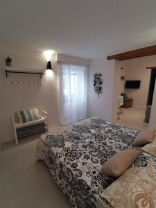 a bedroom with a large bed with a black and white blanket at Via Vittorio Emanuele Apartment in Palermo