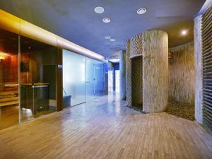a lobby with a stone column in a building at VacationClub - Seaside Apartament 109 in Kołobrzeg