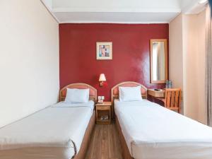 A bed or beds in a room at Hotel Bulevar Tanjung Duren Jakarta