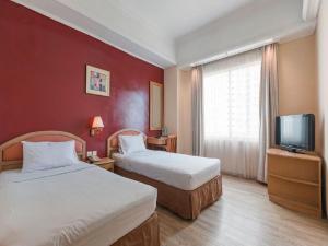 A bed or beds in a room at Hotel Bulevar Tanjung Duren Jakarta