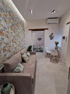 a living room with a couch and a table at Via Vittorio Emanuele Apartment in Palermo