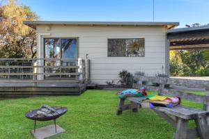 a picnic bench in front of a house at Jetty Road Retreat in Nungurner