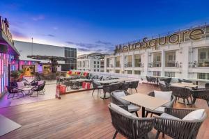 a restaurant with tables and chairs on the roof of a building at Ames Hotel in Melaka