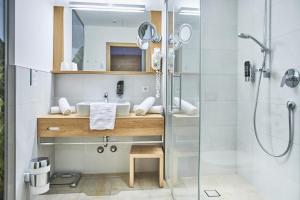 a bathroom with a sink and a shower at Hotel Donauhof in Emmersdorf an der Donau