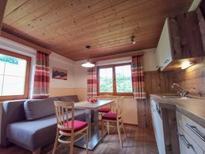 a kitchen and living room with a table and chairs at Ferienhof Haindlbauer in Kirchberg in Tirol