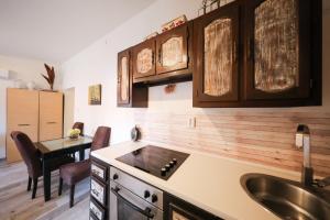 a kitchen with a sink and a table with chairs at Apartment Rita in Zadar +28 photos