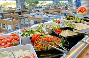 a buffet with several trays of food on a table at Pollis Hotel in Hersonissos