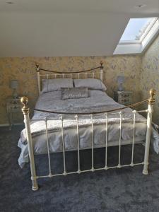 a bedroom with a bed with a metal frame at DRYSTONES in Sidmouth