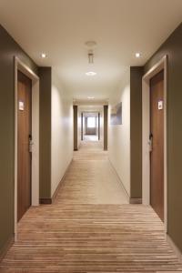 a hallway of an office building with a long corridor at Holiday Inn Express Friedrichshafen, an IHG Hotel in Friedrichshafen