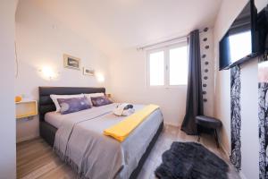 a bedroom with a large bed and a window at Apartment Rita in Zadar