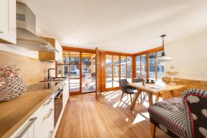 a kitchen and dining room with a table and chairs at Ferienhaus Rosa 1 & 3 in Füssen