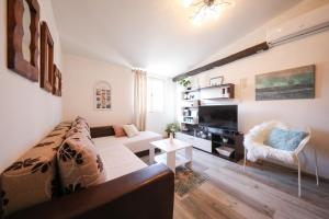 a living room with a couch and a tv at Apartment Rita in Zadar