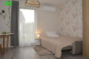 A bed or beds in a room at Apartamenty Homole