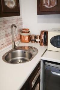 a kitchen counter with a sink and a microwave at Apartment Rita in Zadar
