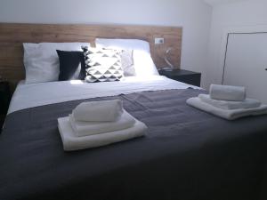 a bed with two towels on top of it at EXCELSIOR Apartments Rovinj in Rovinj