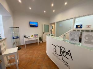 a shop with a counter and a chair in a room at Tropea Boutique Hotel in Tropea