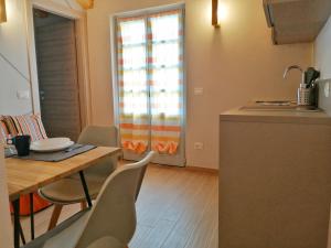 a kitchen and dining room with a table and chairs at FIORDAELISA APARTMENT in Monforte dʼAlba +12 photos