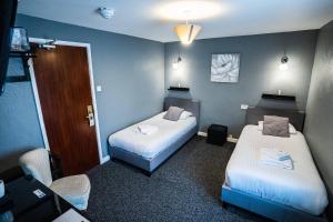 A bed or beds in a room at Bridgemary Manor Hotel & Pub 