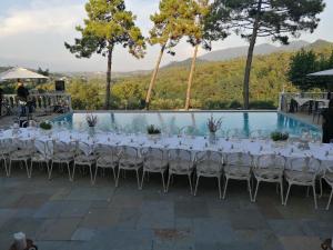 a table set up for a wedding in front of a pool at Hotel Villa Casanova in Lucca