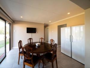 a dining room with a table and chairs and a television at Equestre BnB in Pietermaritzburg